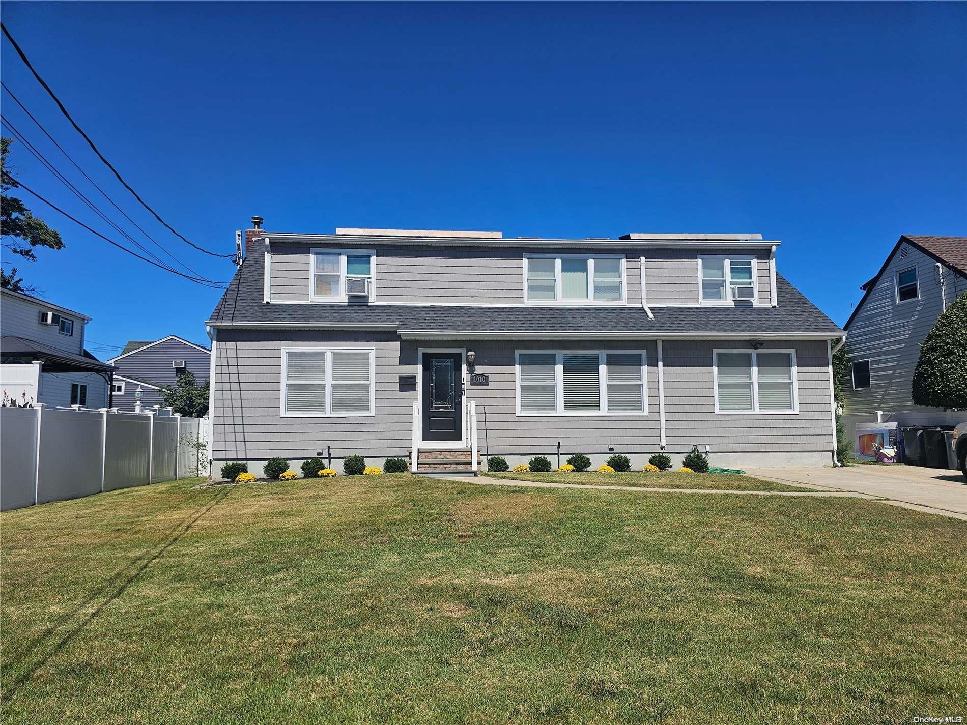 1010 7th Street West Babylon, NY 11704 - Photo 1 of 1 a front view of a house with a yard