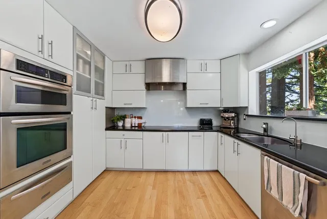 a kitchen with granite countertop a stove a sink and a granite counter tops