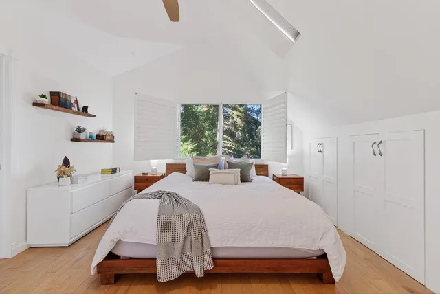 a bedroom with 2 bed and a window