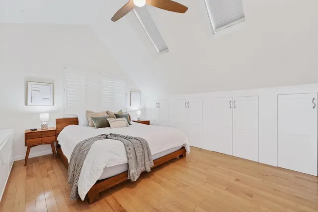 a bedroom with a bed and a lamp