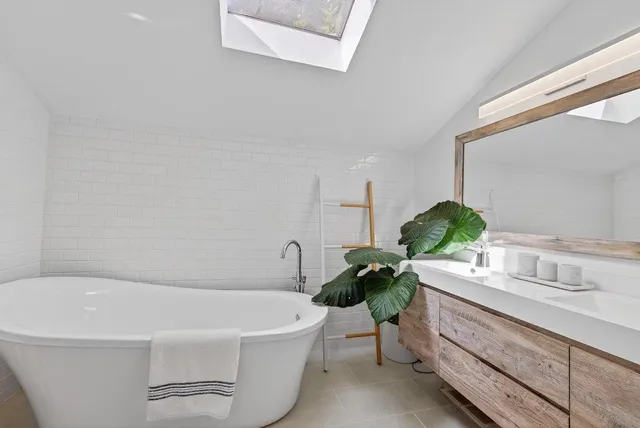 a white bath tub sitting next to a white sink