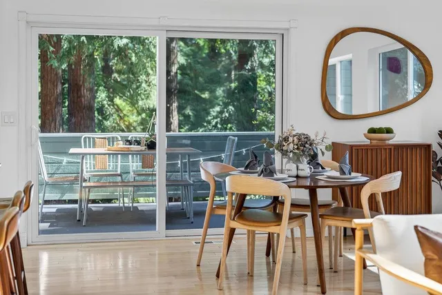 a dining room with furniture and a mirror