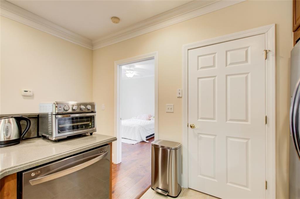 4100 Paces Walk Southeast, Unit 1306 Atlanta, GA 30339 - Photo 11 of 32 a kitchen with stainless steel appliances a stove and a microwave