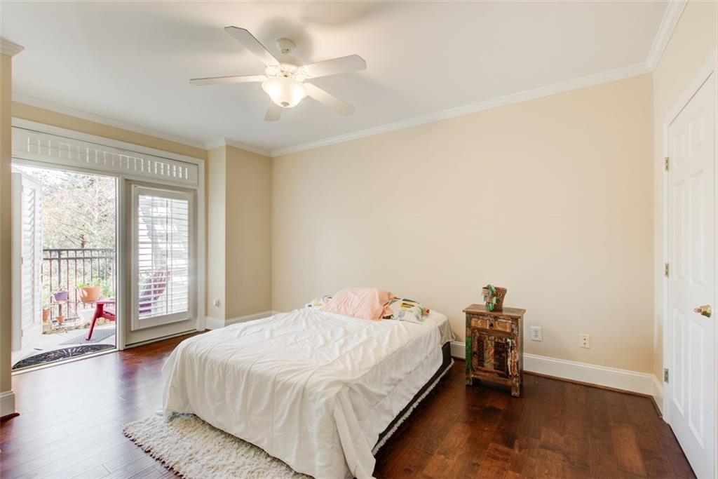 4100 Paces Walk Southeast, Unit 1306 Atlanta, GA 30339 - Photo 12 of 32 a spacious bedroom with a bed and a large window with wooden floor