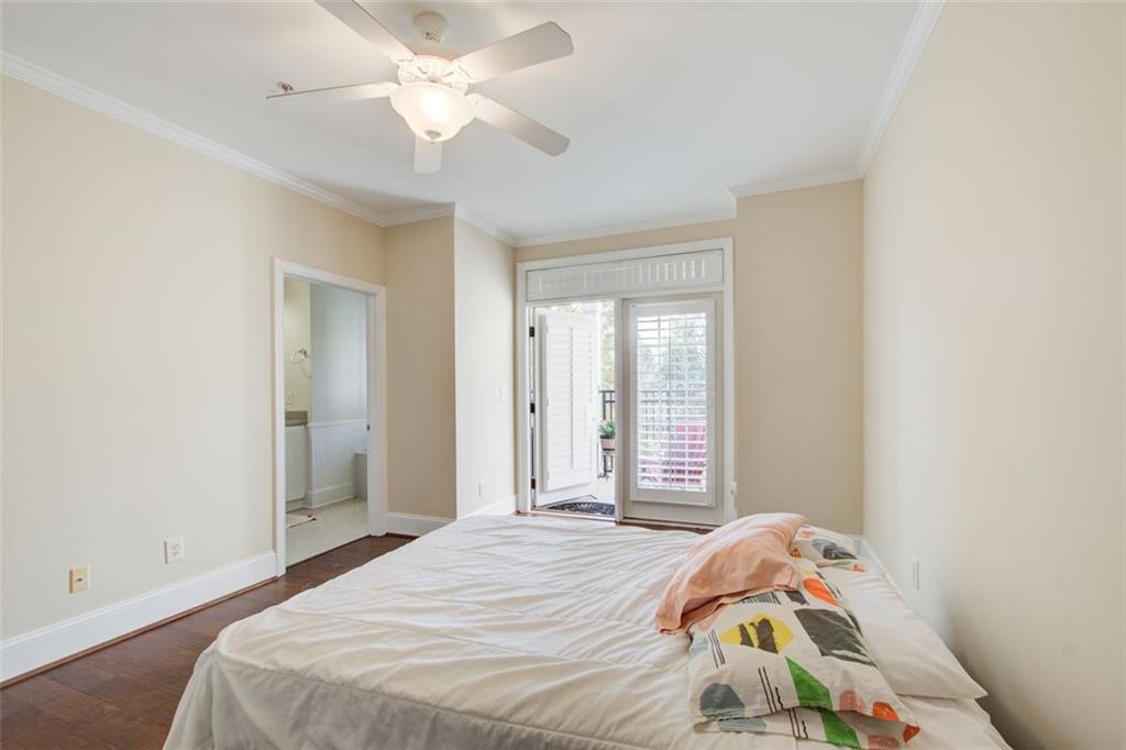 4100 Paces Walk Southeast, Unit 1306 Atlanta, GA 30339 - Photo 14 of 32 a bedroom with a bed and a chandelier