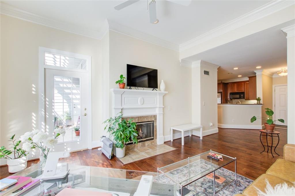 4100 Paces Walk Southeast, Unit 1306 Atlanta, GA 30339 - Photo 21 of 32 a living room with furniture a fireplace and potted plants