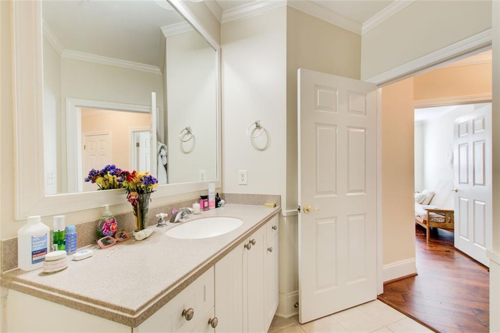 4100 Paces Walk Southeast, Unit 1306 Atlanta, GA 30339 - Photo 24 of 32 a bathroom with a sink and a mirror