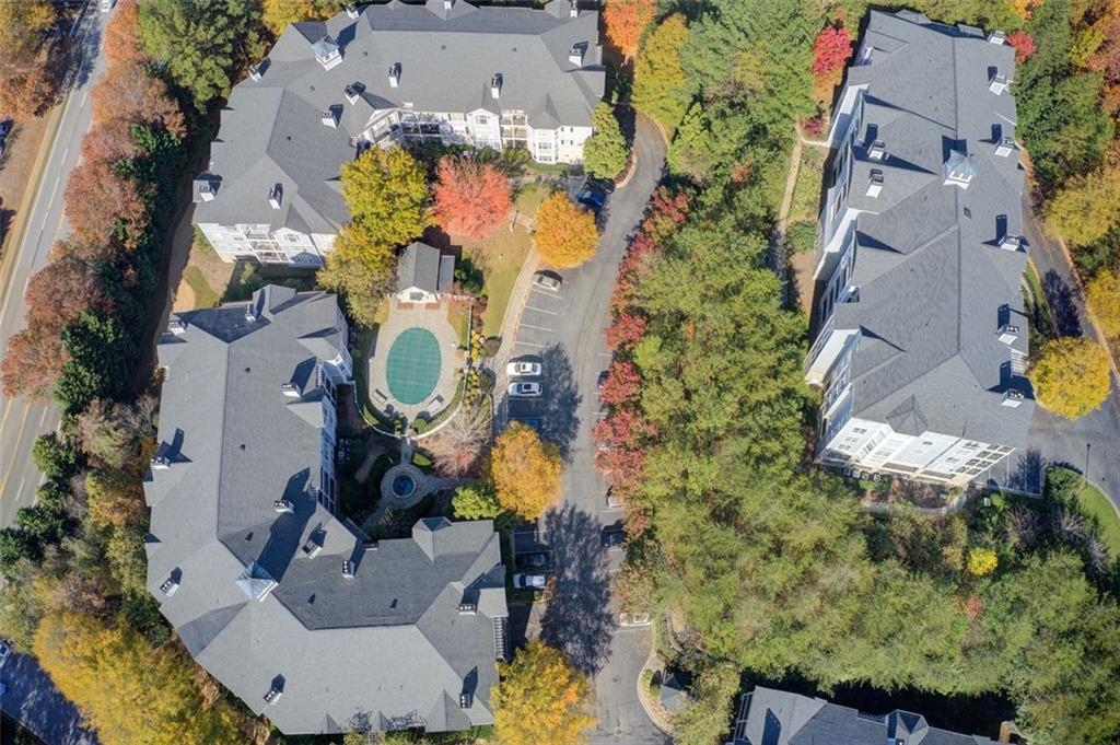 4100 Paces Walk Southeast, Unit 1306 Atlanta, GA 30339 - Photo 31 of 32 an aerial view of a house with swimming pool and large trees