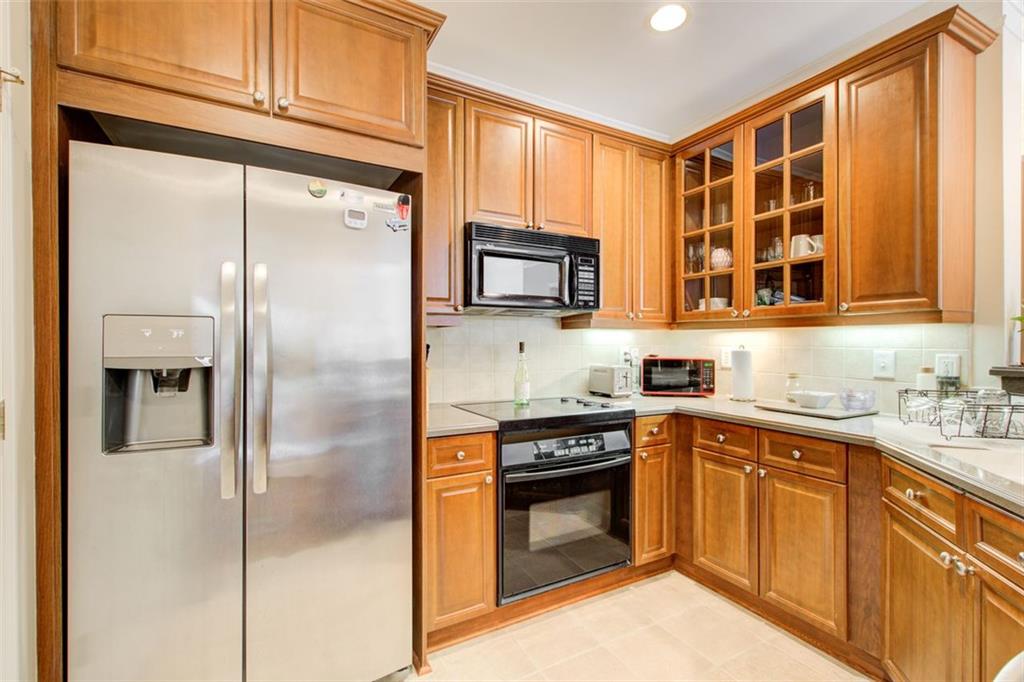 4100 Paces Walk Southeast, Unit 1306 Atlanta, GA 30339 - Photo 10 of 32 a kitchen with stainless steel appliances granite countertop a refrigerator a sink and a stove
