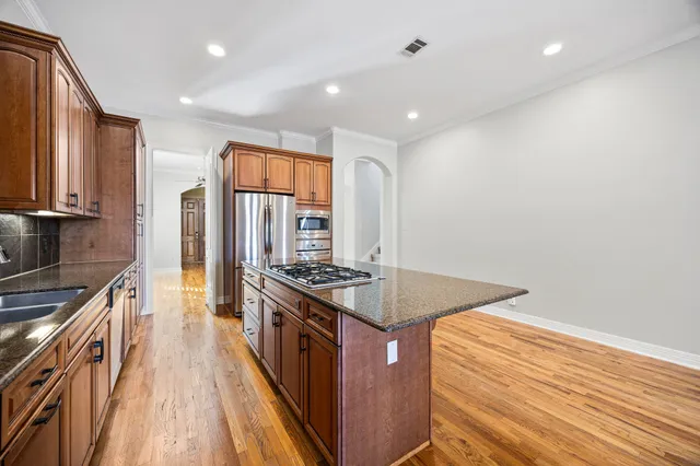 a kitchen with stainless steel appliances granite countertop a stove and a sink