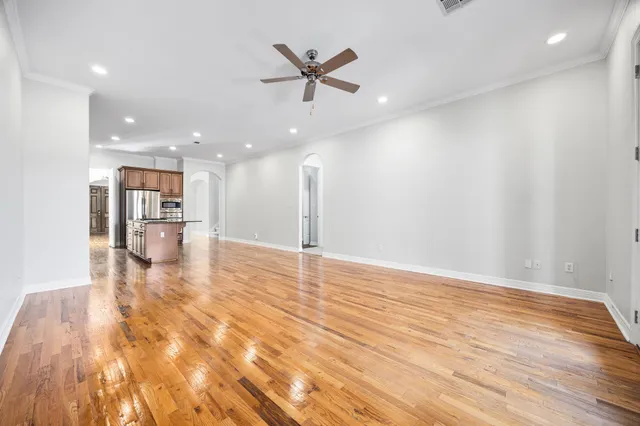 a view of a livingroom with a ceiling fan and wooden floor