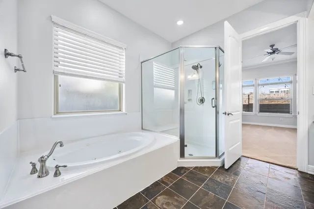 a bathroom with a bathtub and a shower