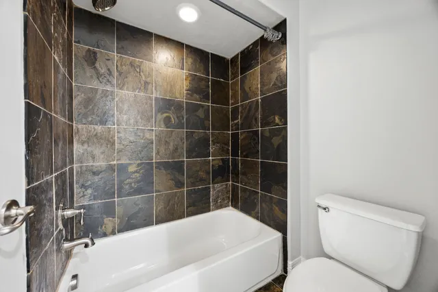 a bathroom with a toilet and bathtub