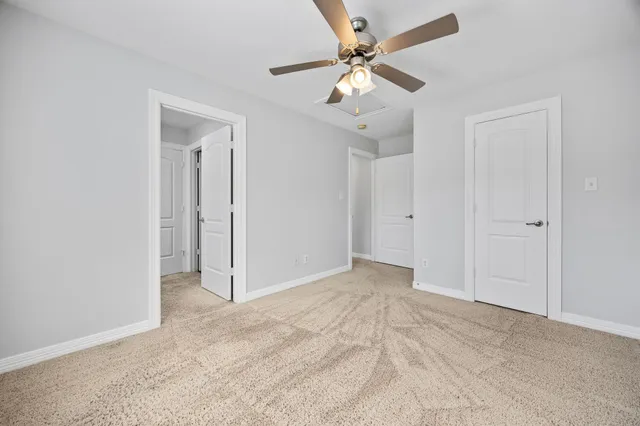 an empty room with fan and a ceiling fan