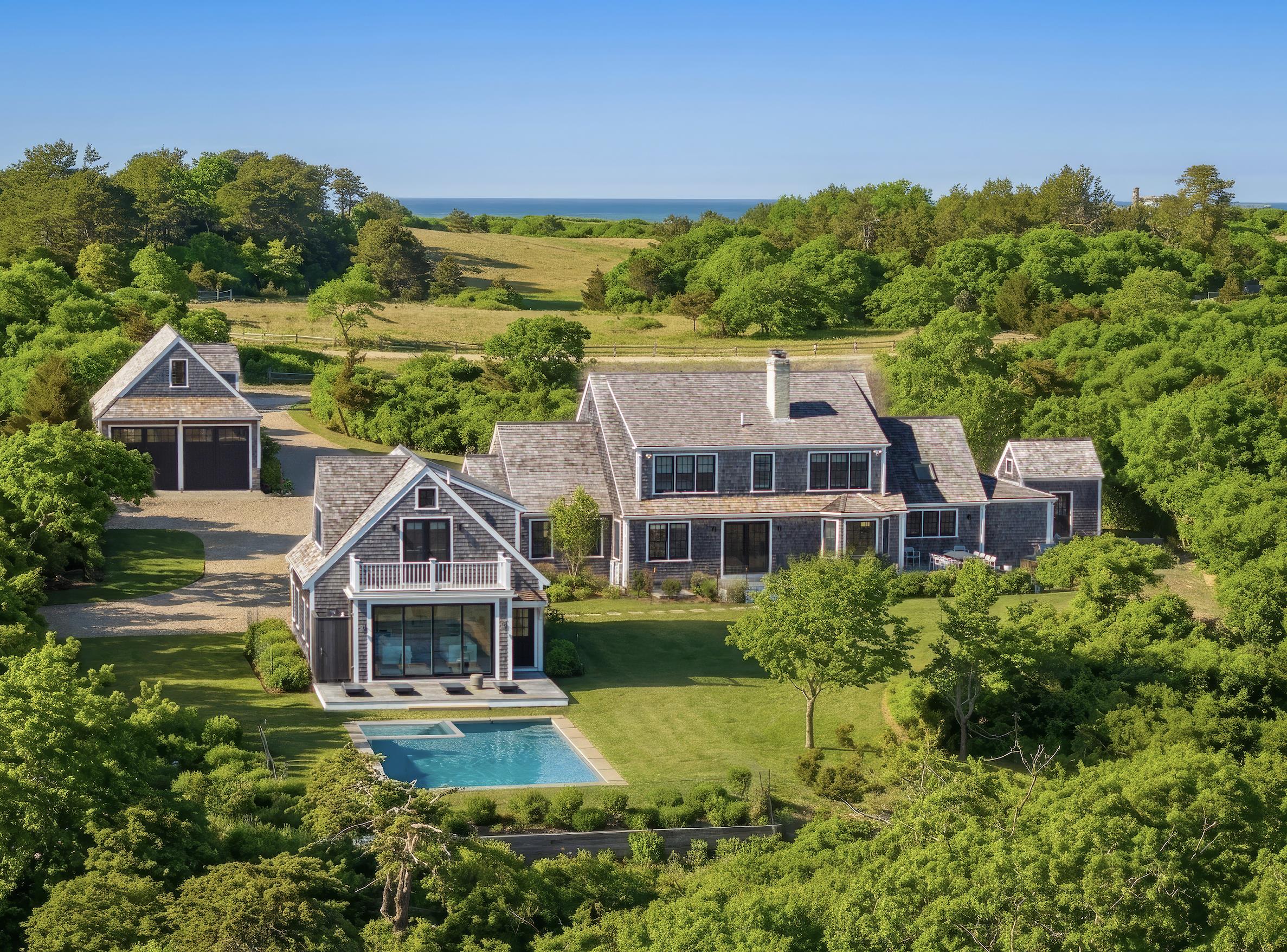 174 Cliff Road Nantucket, MA 02554 - Photo 1 of 49 a front view of a house with a yard