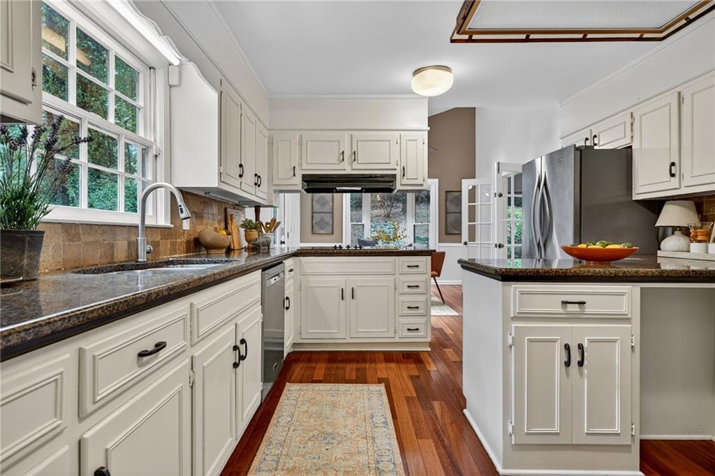 7565 Ball Mill Road Northeast Atlanta, GA 30350 - Photo 23 of 61 a kitchen with white cabinets and window