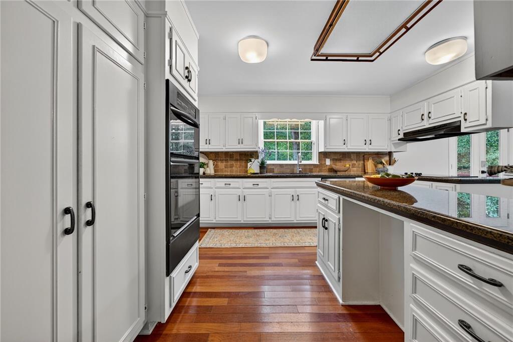 7565 Ball Mill Road Northeast Atlanta, GA 30350 - Photo 24 of 61 a kitchen with stainless steel appliances sink a microwave and cabinets