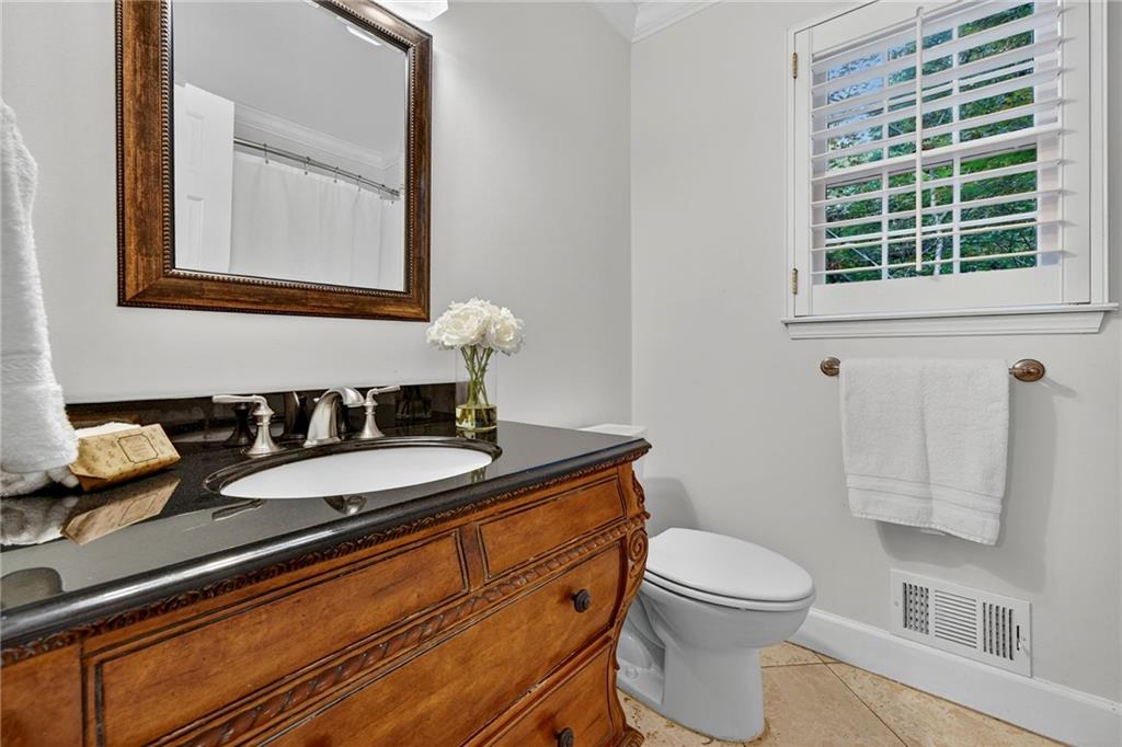 7565 Ball Mill Road Northeast Atlanta, GA 30350 - Photo 32 of 61 a bathroom with a granite countertop toilet sink and mirror