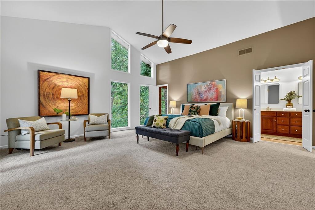 7565 Ball Mill Road Northeast Atlanta, GA 30350 - Photo 9 of 61 a spacious bedroom with a bed and a chandelier