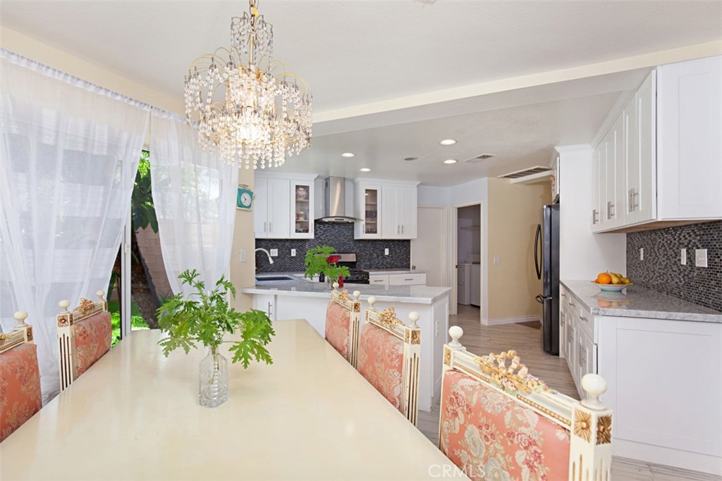 19 Tennessee Irvine, CA 92606 - Photo 12 of 40 a kitchen with stainless steel appliances kitchen island granite countertop a table and a refrigerator
