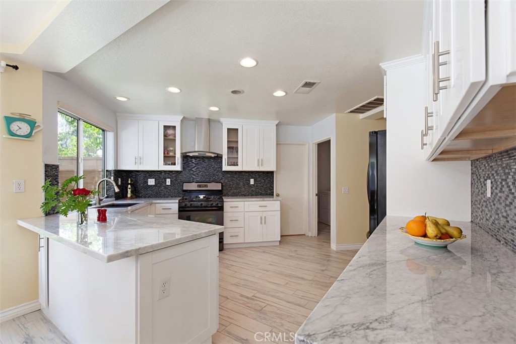 19 Tennessee Irvine, CA 92606 - Photo 13 of 40 a kitchen with stainless steel appliances granite countertop a refrigerator sink and stove