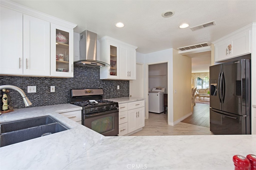 19 Tennessee Irvine, CA 92606 - Photo 14 of 40 a kitchen with stainless steel appliances granite countertop a refrigerator a stove a sink and a microwave