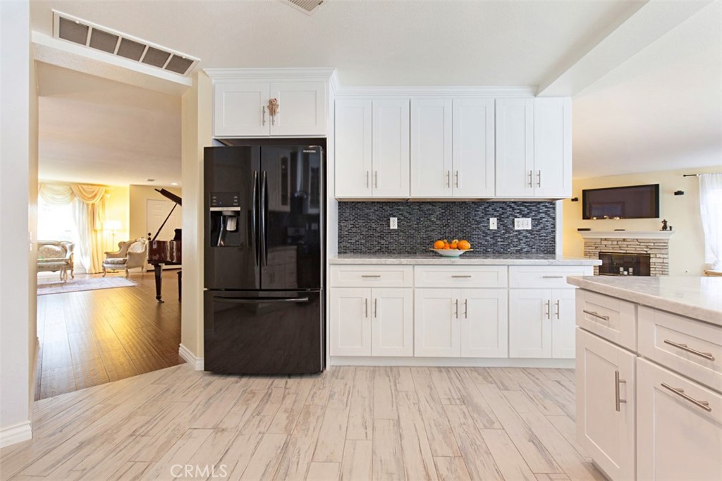 19 Tennessee Irvine, CA 92606 - Photo 16 of 40 a kitchen with a refrigerator stove and white cabinets