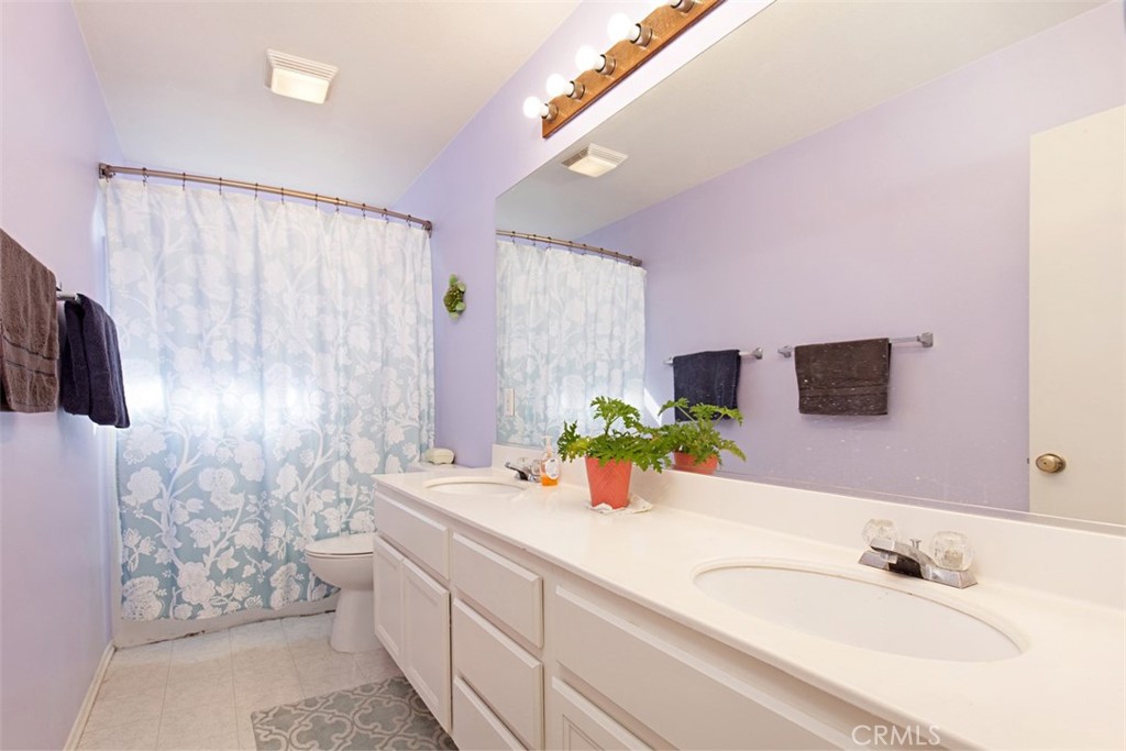 19 Tennessee Irvine, CA 92606 - Photo 23 of 40 a bathroom with a granite countertop sink and a large mirror