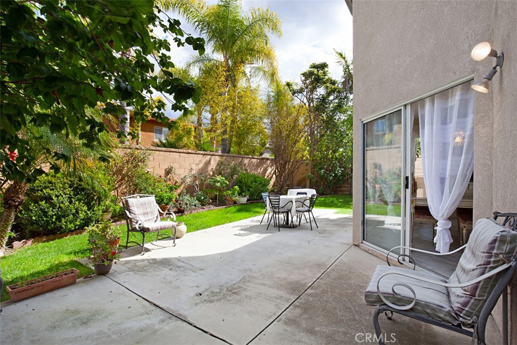 19 Tennessee Irvine, CA 92606 - Photo 31 of 40 a view of backyard with a table and chairs and a large tree