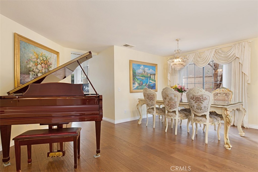 19 Tennessee Irvine, CA 92606 - Photo 7 of 40 a dining room with wooden floor a glass table and chairs