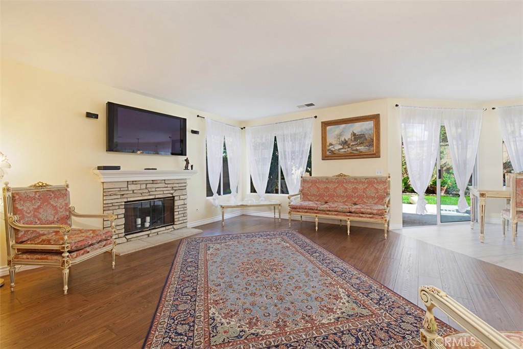 19 Tennessee Irvine, CA 92606 - Photo 8 of 40 a living room with furniture a fireplace and a flat screen tv