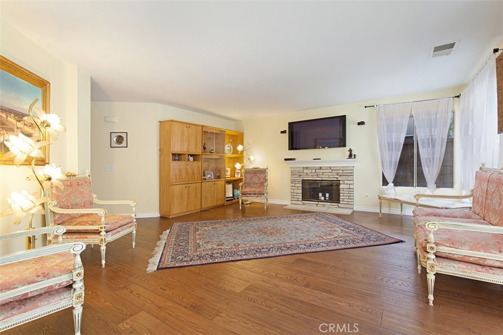 19 Tennessee Irvine, CA 92606 - Photo 9 of 40 a living room with furniture a flat screen tv and a fireplace