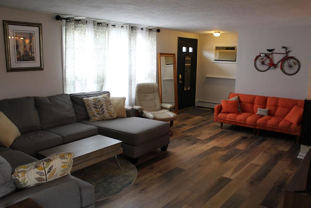 154 Ravenswood Road Waltham, MA 02453 - Photo 2 of 11 a living room with furniture and a window