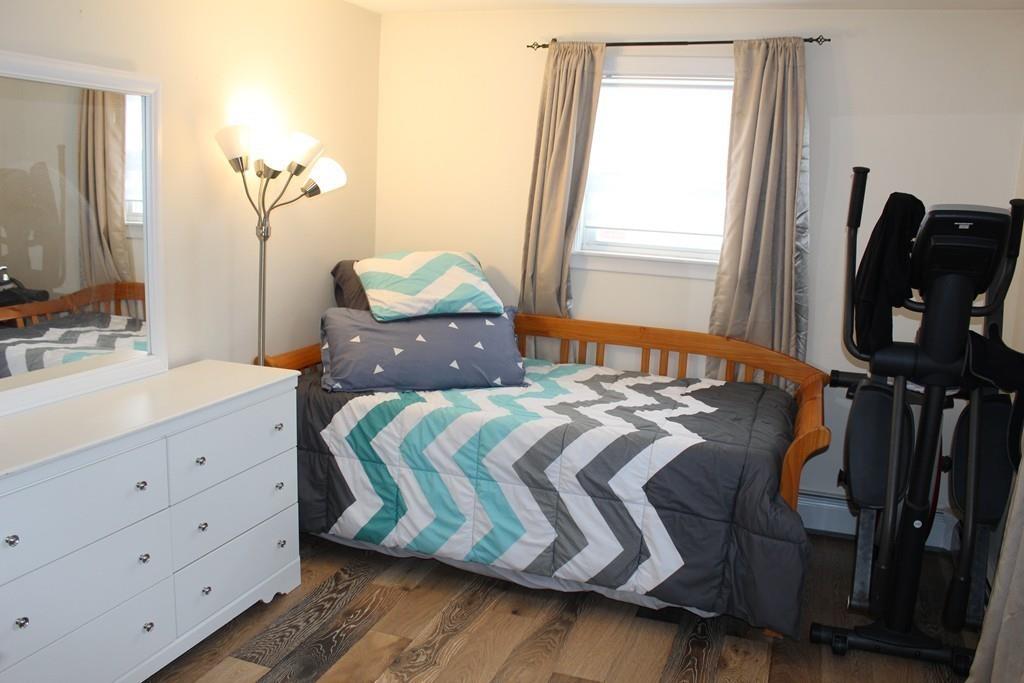 154 Ravenswood Road Waltham, MA 02453 - Photo 8 of 11 a bedroom with a bed and wooden floor