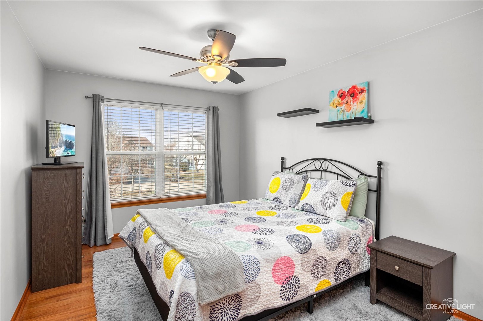 7651 Pin Oak Court Plainfield, IL 60586 - Photo 22 of 31 a bedroom with a bed and wooden floor
