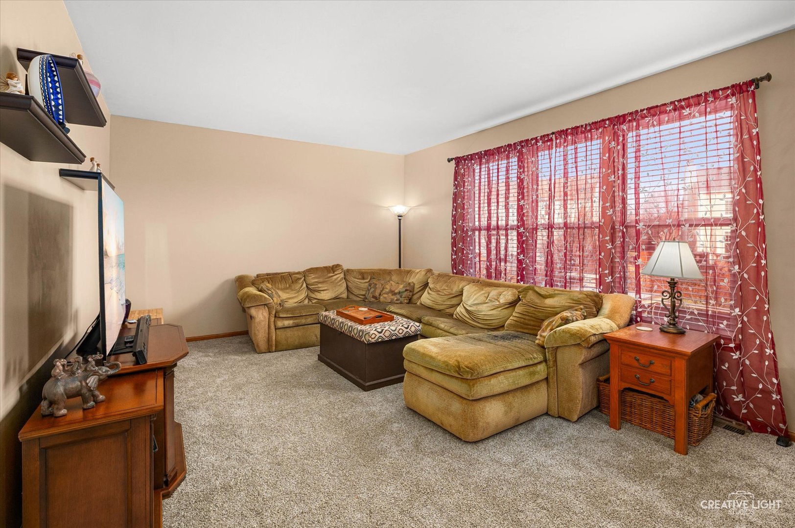 7651 Pin Oak Court Plainfield, IL 60586 - Photo 10 of 31 a living room with furniture a flat screen tv and a window