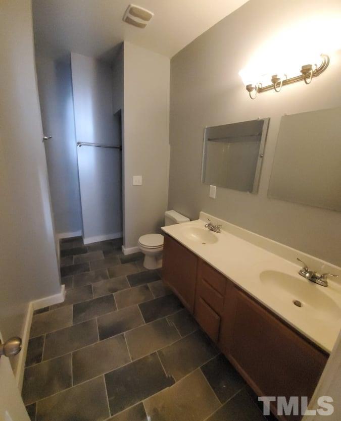 2533 Friendly Trail Raleigh, NC 27610 - Photo 12 of 20 a bathroom with a sink and a mirror