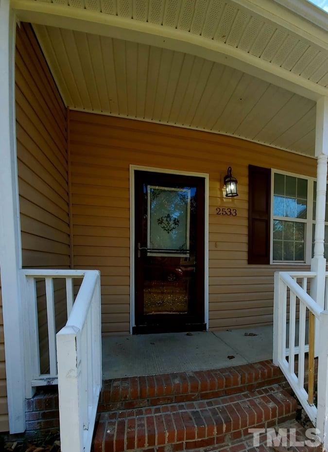 2533 Friendly Trail Raleigh, NC 27610 - Photo 3 of 20 a front view of a house with stairs