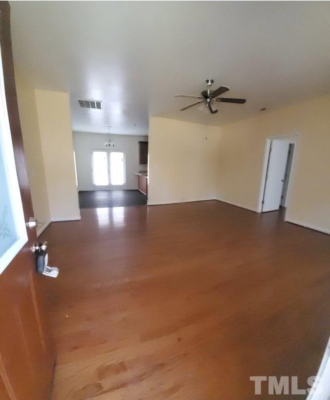 2533 Friendly Trail Raleigh, NC 27610 - Photo 4 of 20 an empty room with windows and cabinet
