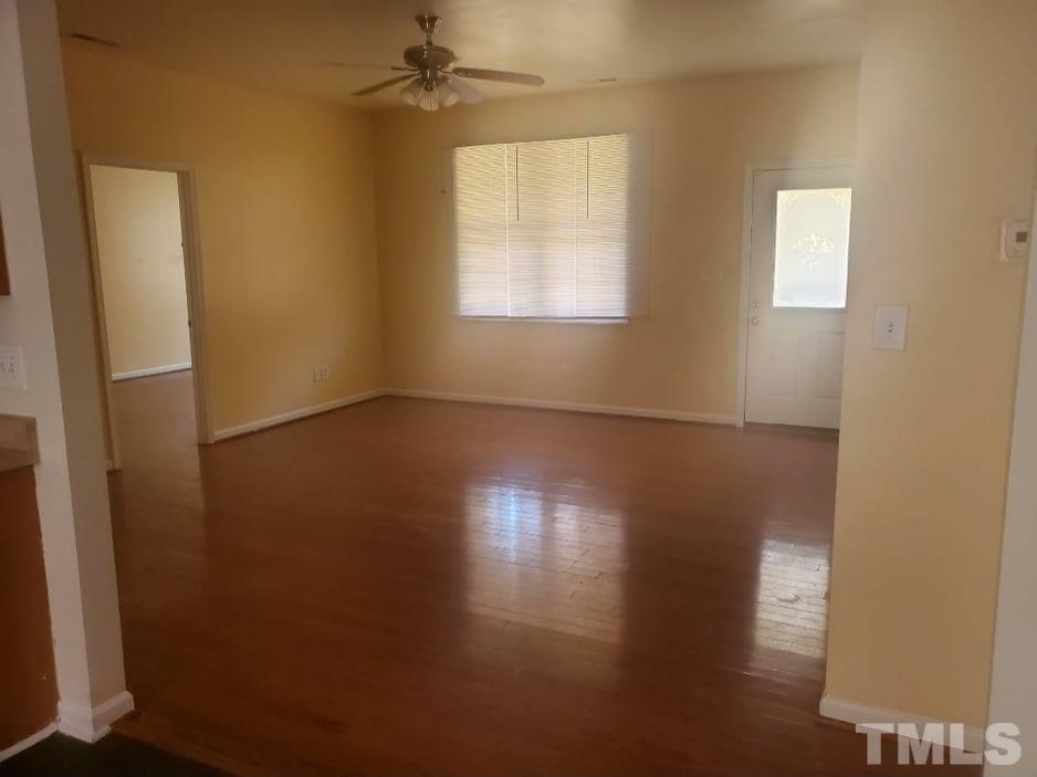 2533 Friendly Trail Raleigh, NC 27610 - Photo 5 of 20 an empty room with wooden floor and windows