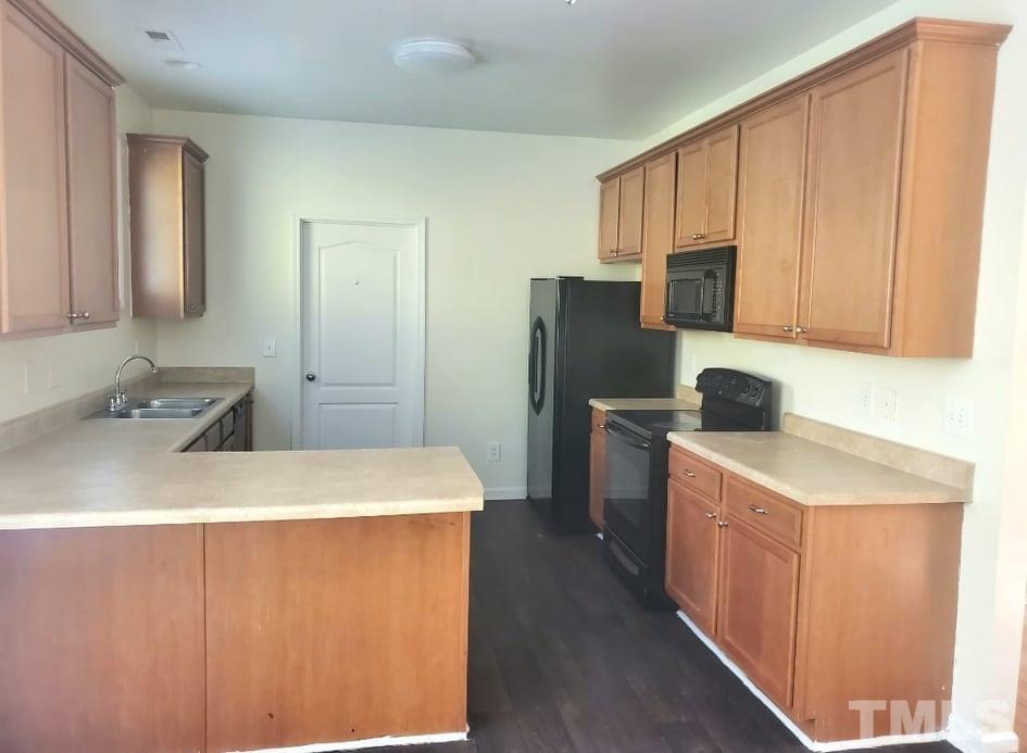 2533 Friendly Trail Raleigh, NC 27610 - Photo 7 of 20 a kitchen with stainless steel appliances a refrigerator sink and cabinets