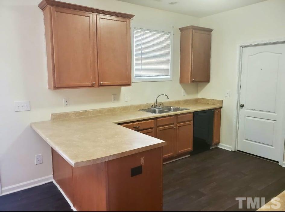 2533 Friendly Trail Raleigh, NC 27610 - Photo 8 of 20 a kitchen with a sink a stove and cabinets