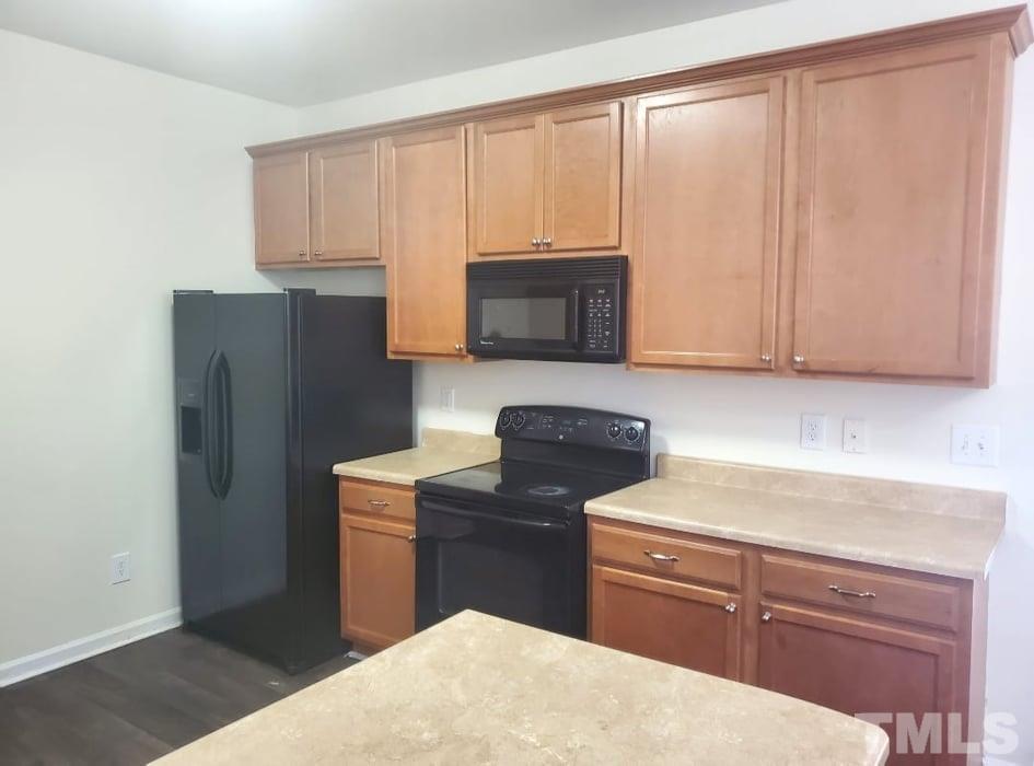 2533 Friendly Trail Raleigh, NC 27610 - Photo 9 of 20 a kitchen with a refrigerator stove and microwave