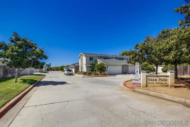 a wooden bench sitting in front of a building