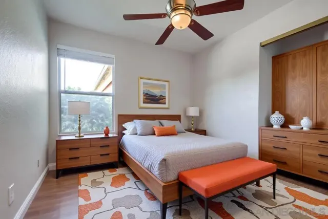 a bedroom with a bed and a dresser in it