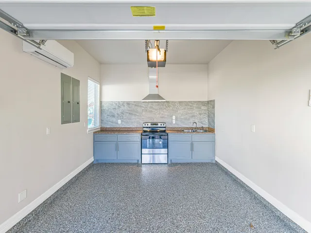 a kitchen with granite countertop a sink stove and cabinets