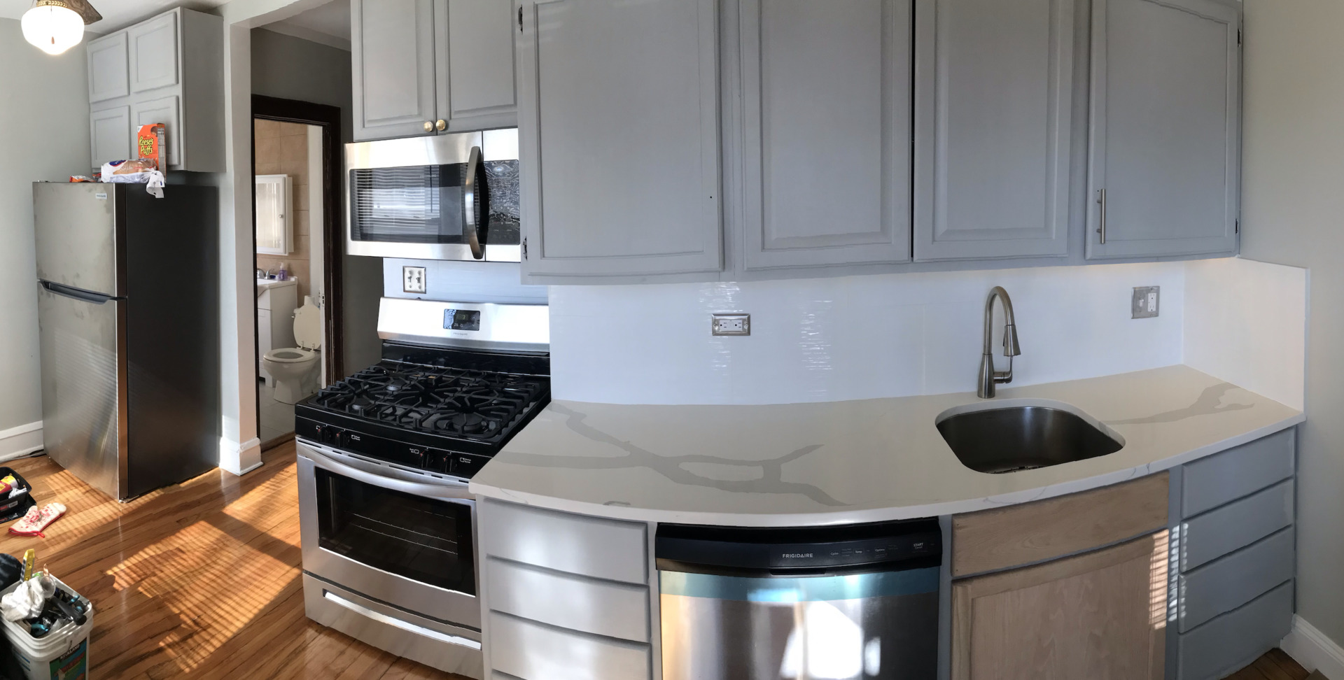2455 North Laramie Avenue Chicago, IL 60639 - Photo 4 of 5 a kitchen with stainless steel appliances a stove and a sink