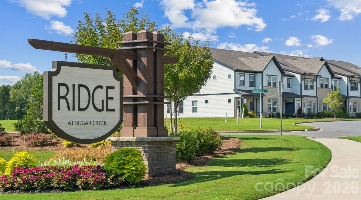 8668 Miles Gap Road Indian Land, SC 29707 - Photo 20 of 28 a view of a house with a front yard and a bench
