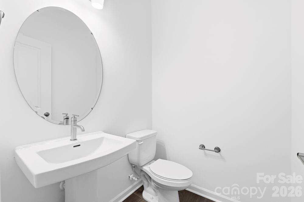 8668 Miles Gap Road Indian Land, SC 29707 - Photo 7 of 28 a bathroom with a sink a toilet and a mirror