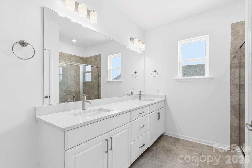 8668 Miles Gap Road Indian Land, SC 29707 - Photo 10 of 28 a bathroom with a sink double vanity and a mirror